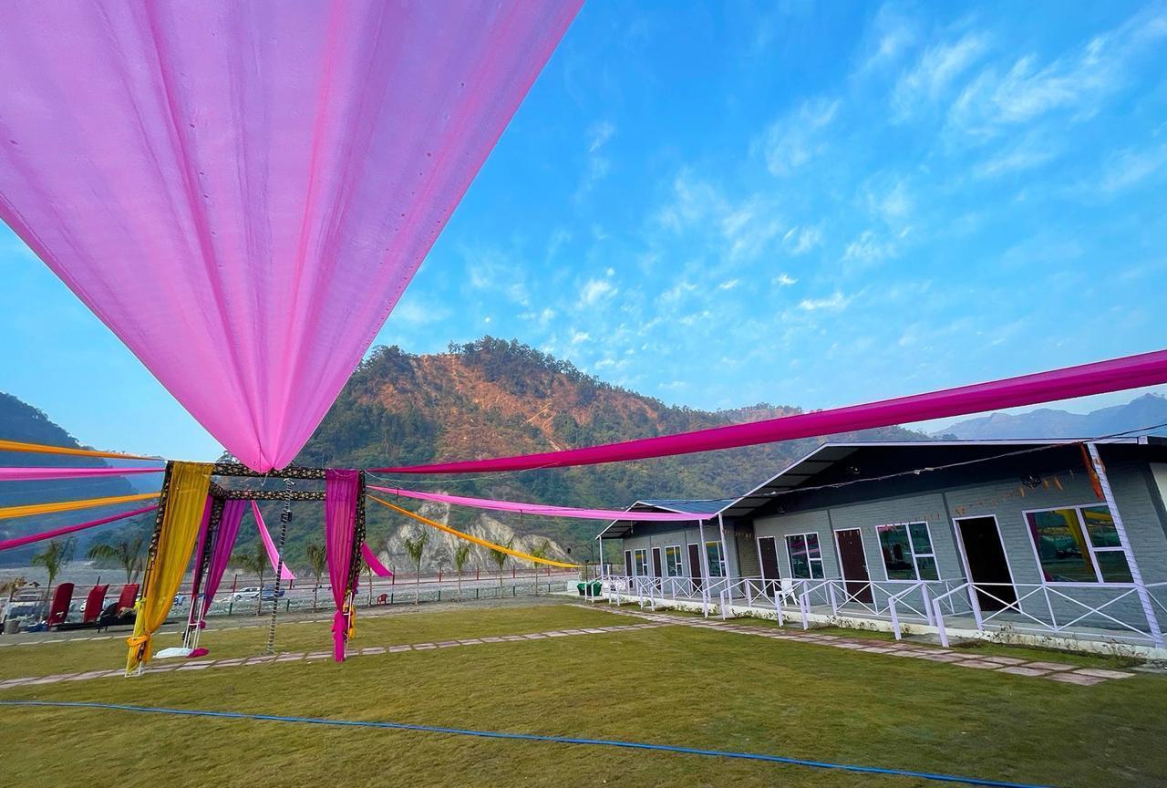 Open lawn with mountain views at riverside resort in Rishikesh
